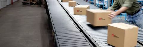 Boxes on a conveyer belt with SiTime logo on them