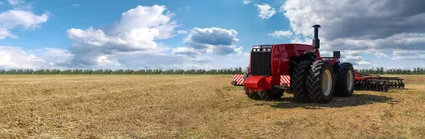 Autonomous unmanned tractor with plow working on the field