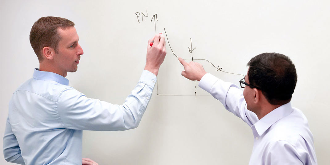 SiTime employees in front of a white board