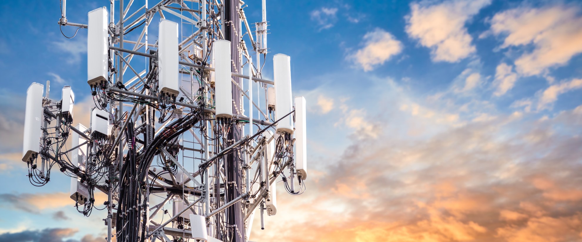 communications tower with blue and orange sky