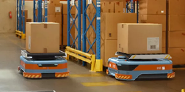Automated Modern Retail Warehouse AGV Robots Transporting Cardboard Boxes in Distribution Logistics Center