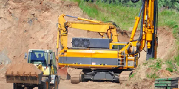 Drilling rig and pile driver at construction site