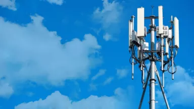 5G cell tower against a blue sky