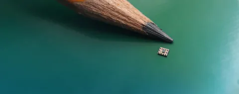 Symphonic™ Mobile Clock Generator SiT30100 shown next to a pencil lead to highlight its small size