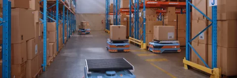 Automated Modern Retail Warehouse AGV Robots Transporting Cardboard Boxes in Distribution Logistics Center