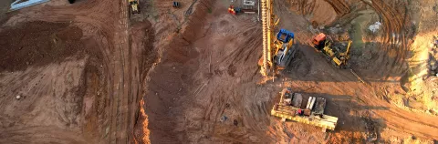 Drilling rig and pile driver at construction site