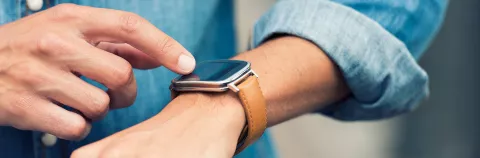 Man in the street using his smart-watch