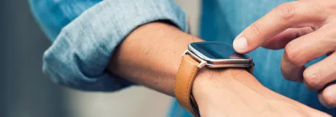 Man in the city using his smart-watch app