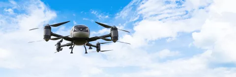 An unmanned passenger drone (air taxi) flying in the sky
