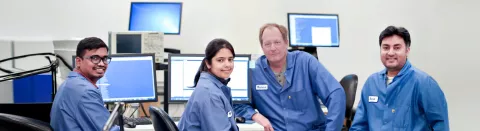 Group of four engineers testing timing devices