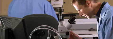 Scientists using microscope
