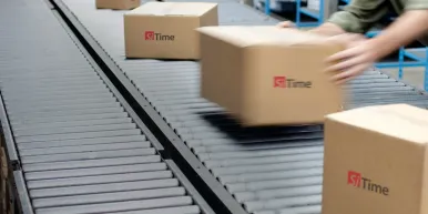 Boxes on a conveyer belt with SiTime logo on them